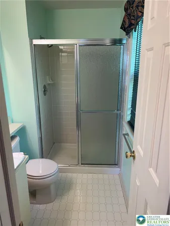 a bathroom with a toilet and a shower