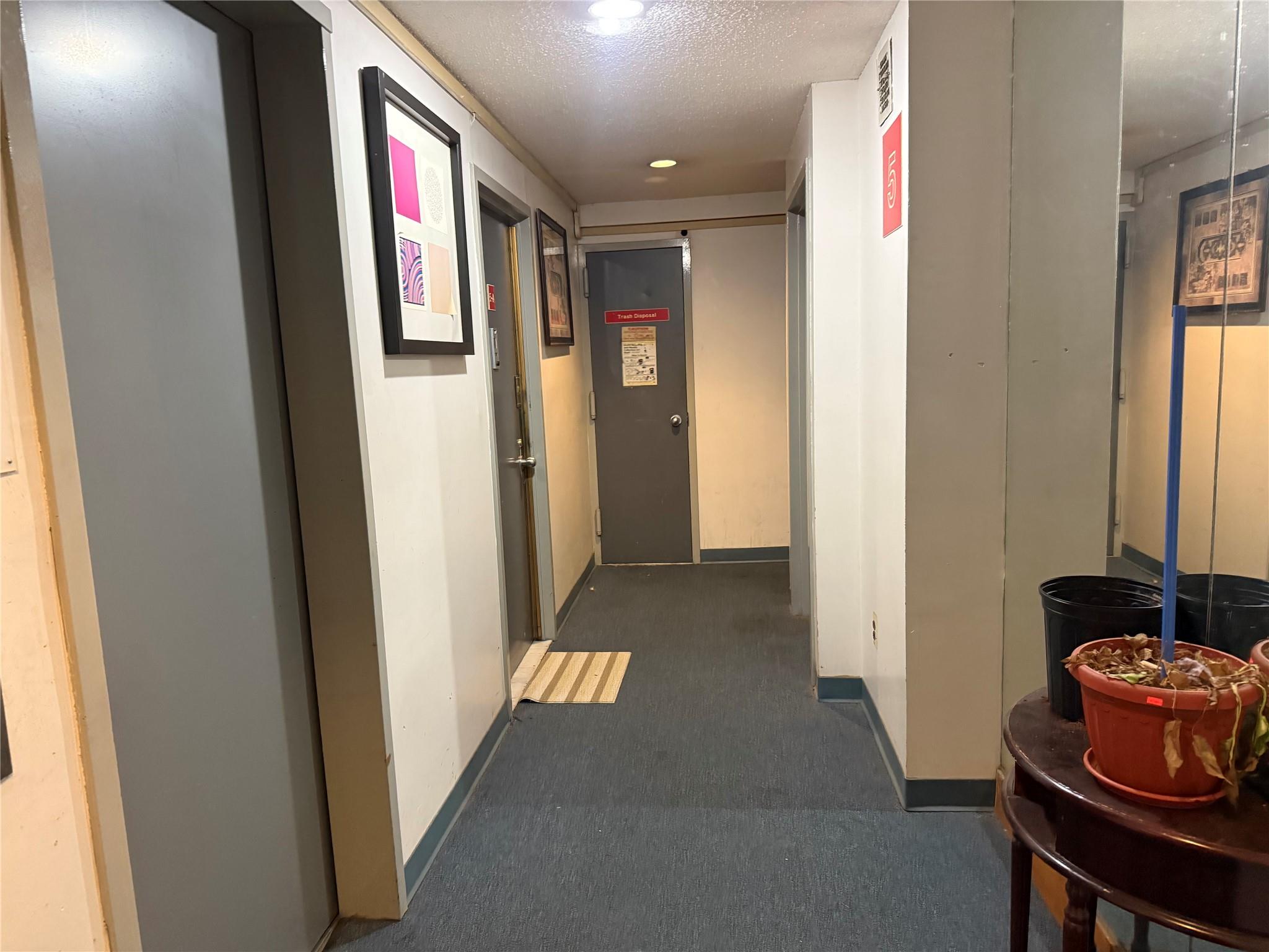 81-09 41st Avenue, Unit 5B Queens, NY 11373 - Photo 21 of 25 5th floor hallway featuring carpet flooring.