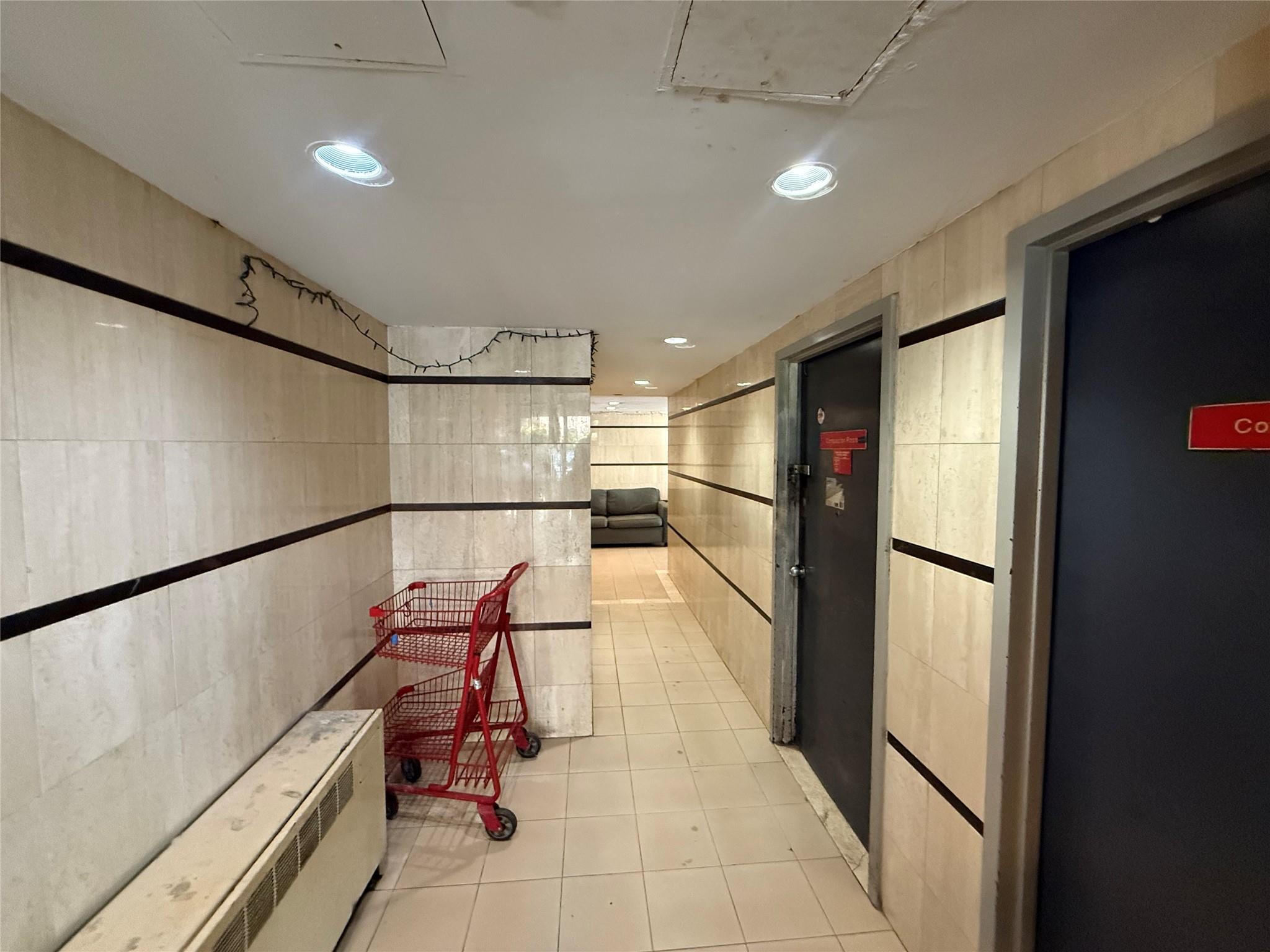 81-09 41st Avenue, Unit 5B Queens, NY 11373 - Photo 23 of 25 Hallway featuring tile walls, light tile patterned floors, and recessed lighting