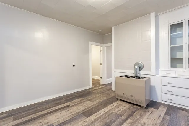 a view of kitchen with wooden floor and electronic appliances