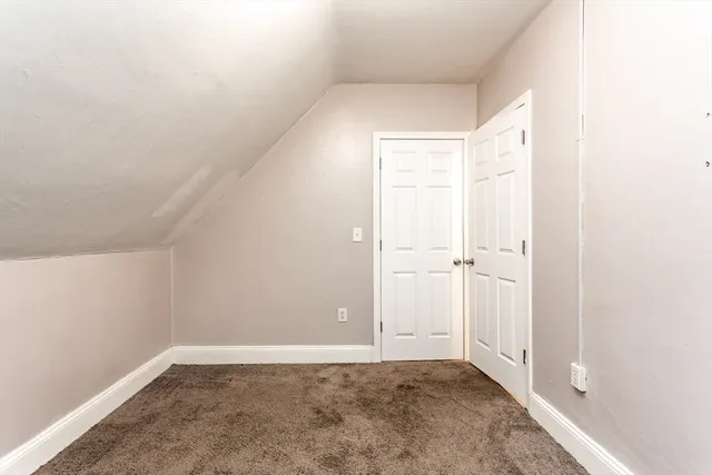 a view of bathroom with sink toilet and window