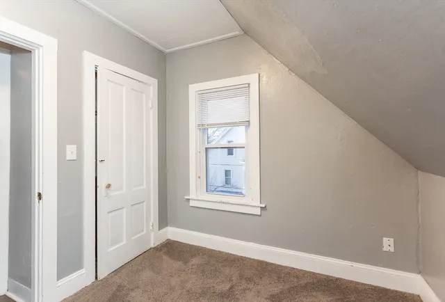 a view of a big room with closet and windows