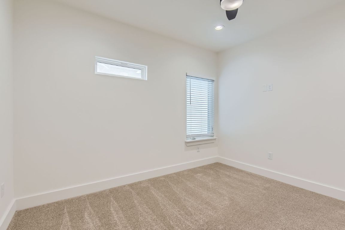 6820 Blue Dawn Trail, Unit 104 Austin, TX 78744 - Photo 6 of 9 Spare room featuring carpet flooring and recessed lighting