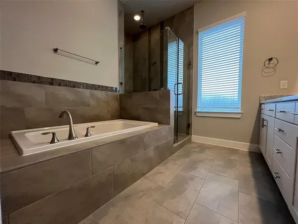 an empty room with a ceiling fan and window