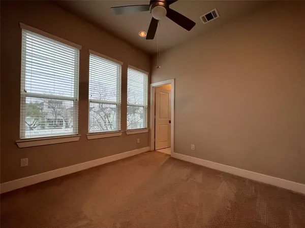 a bathroom with a white toilet and a shower