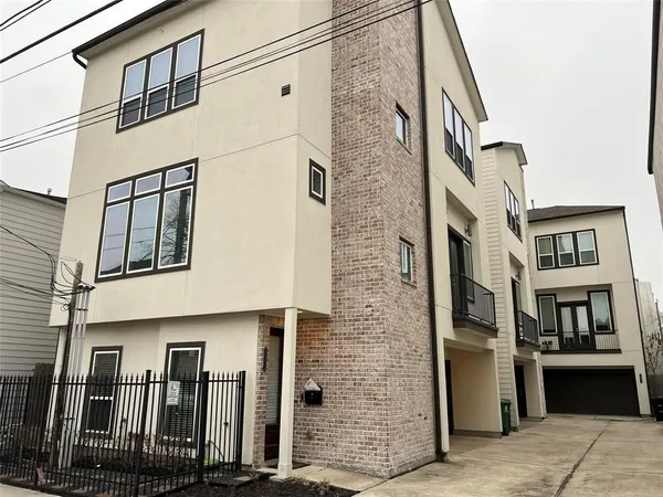a view of an entryway with wooden floor stairs and a chandelier