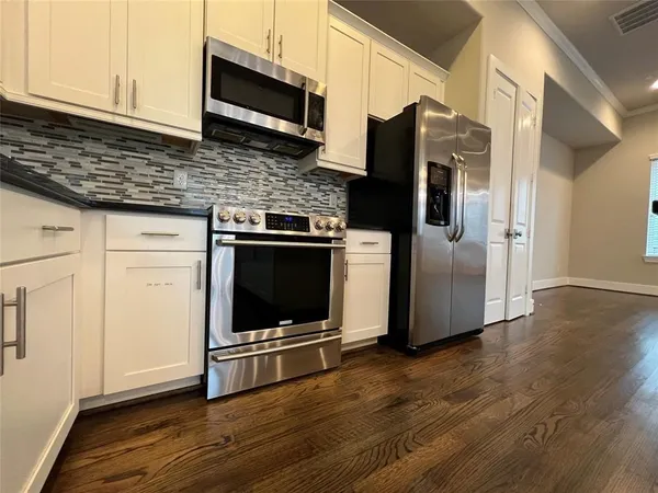a kitchen with granite countertop wooden cabinets a sink and dishwasher