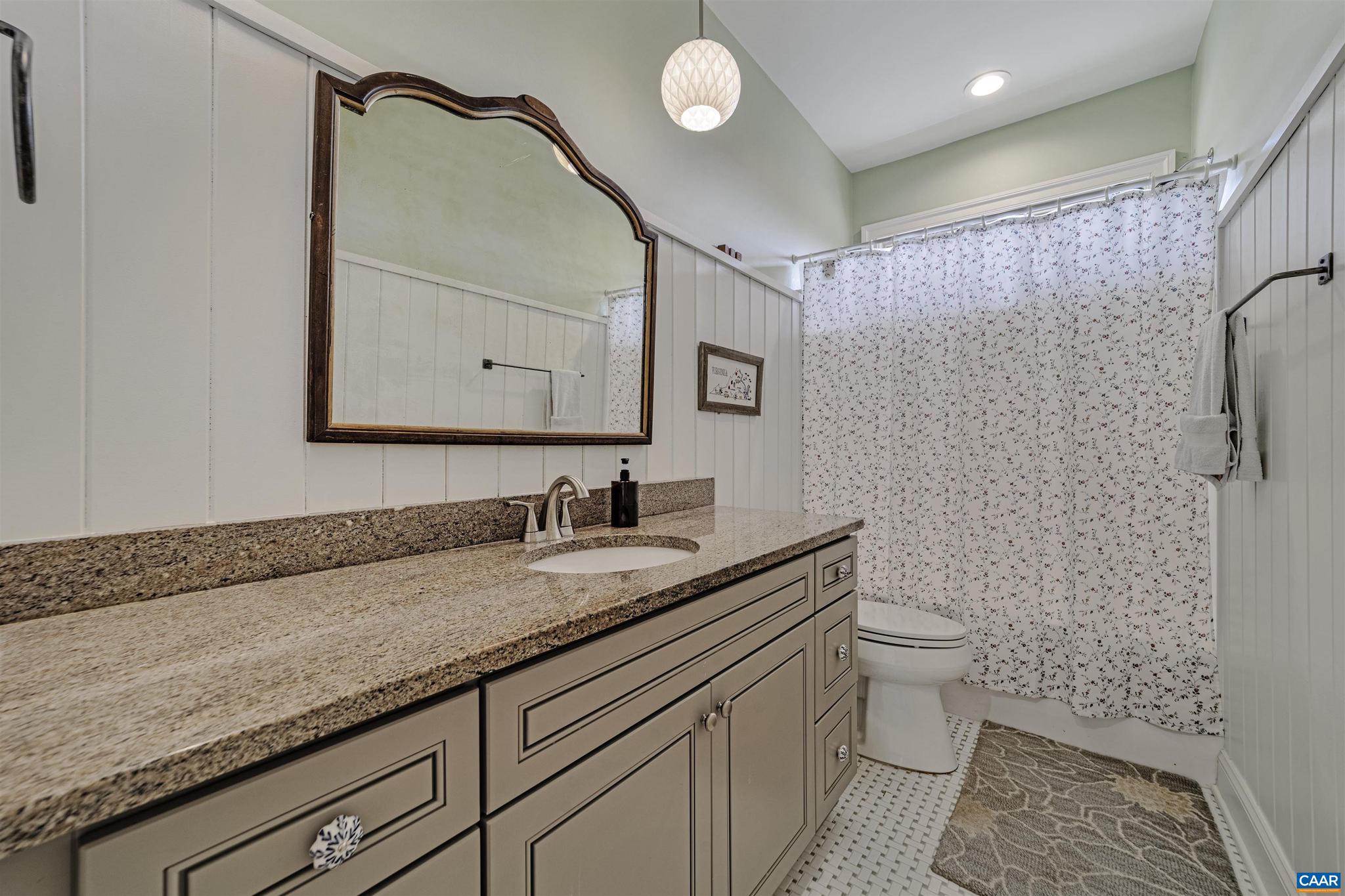 4337 Riddles Bridge Road Goochland, VA 23063 - Photo 22 of 43 a bathroom with a granite countertop sink a toilet and a mirror