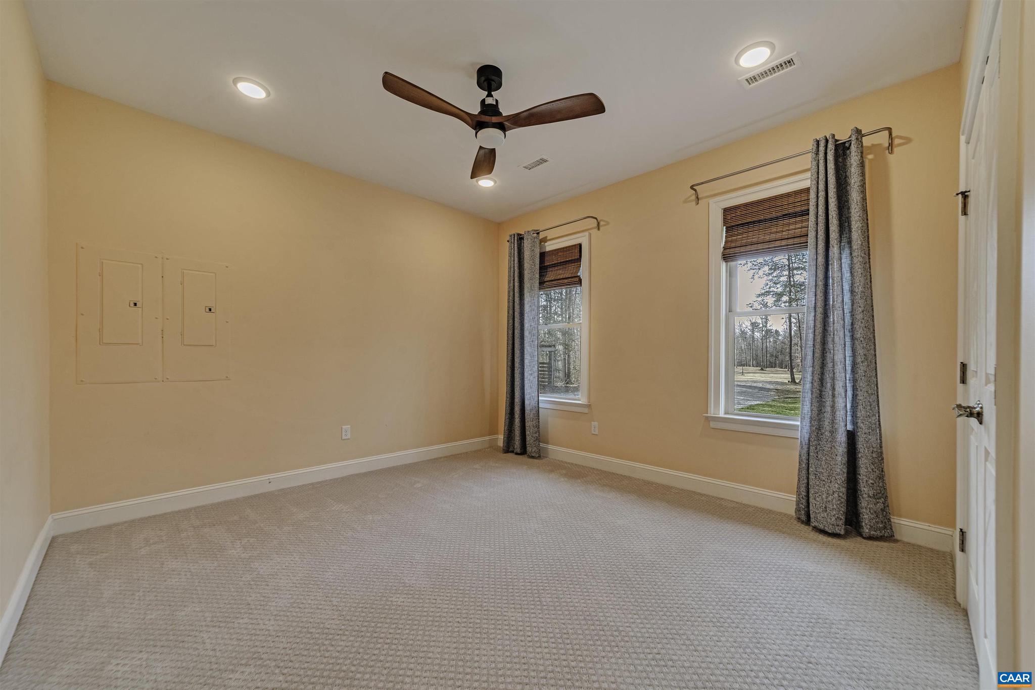 4337 Riddles Bridge Road Goochland, VA 23063 - Photo 23 of 43 a view of a livingroom with a ceiling fan & windows