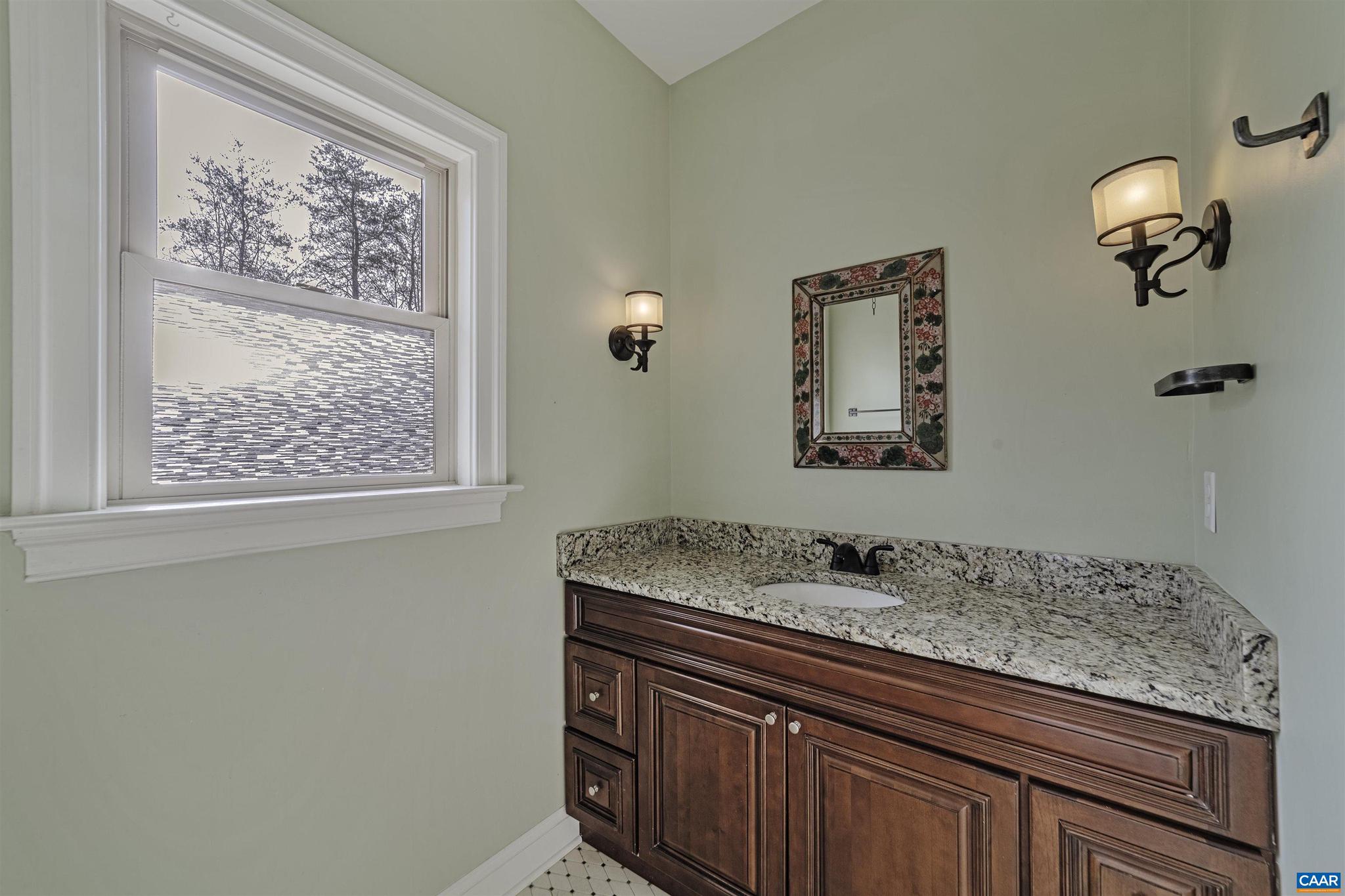 4337 Riddles Bridge Road Goochland, VA 23063 - Photo 28 of 43 a bathroom with a granite countertop sink and a mirror