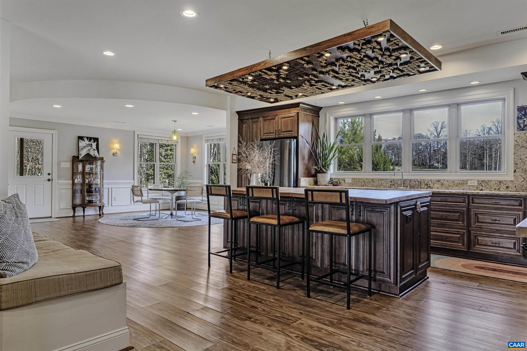 4337 Riddles Bridge Road Goochland, VA 23063 - Photo 6 of 43 an open kitchen with granite countertop a stove and a wooden floors