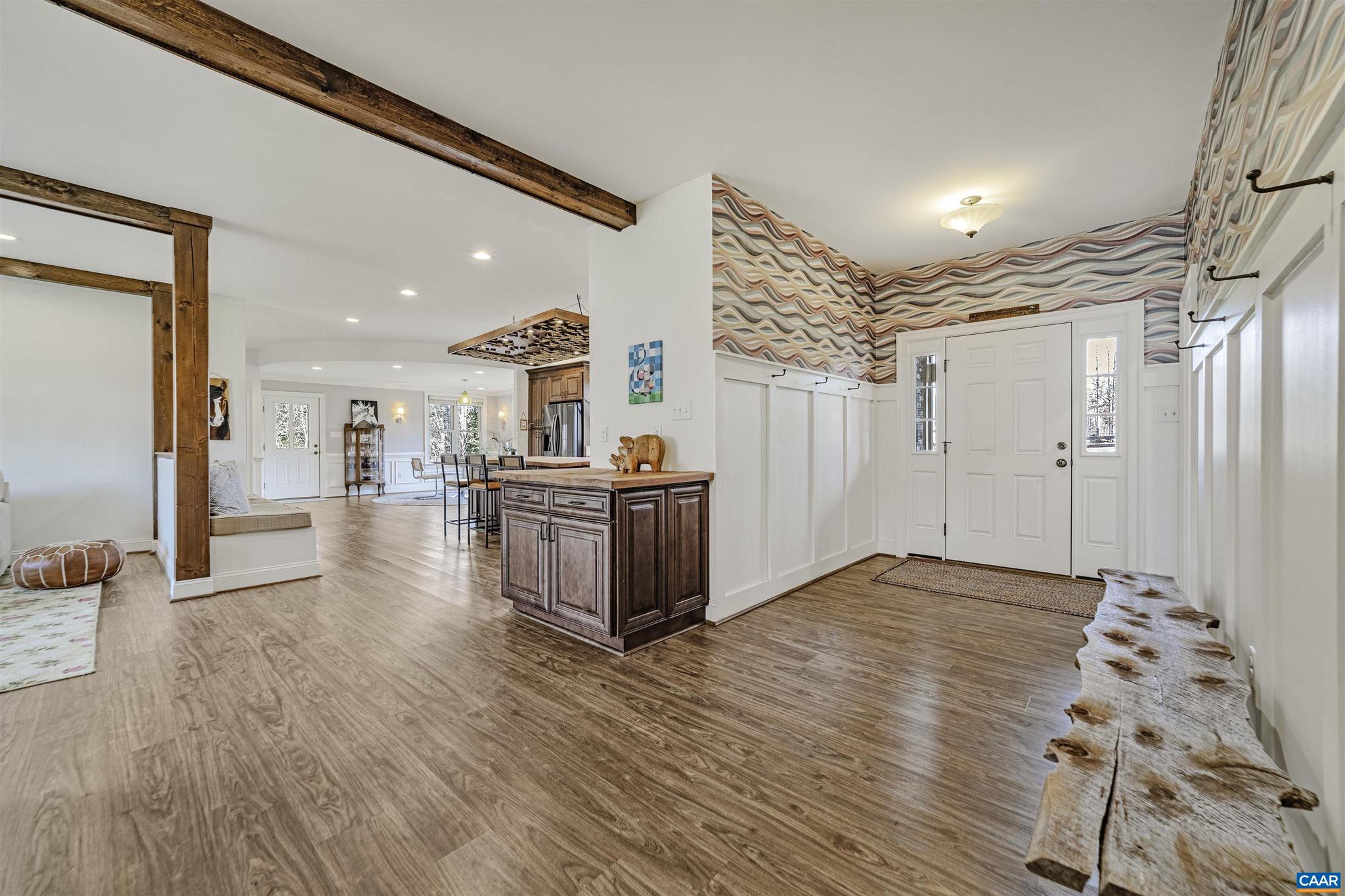4337 Riddles Bridge Road Goochland, VA 23063 - Photo 10 of 43 a view of a livingroom with furniture wooden floor and a kitchen