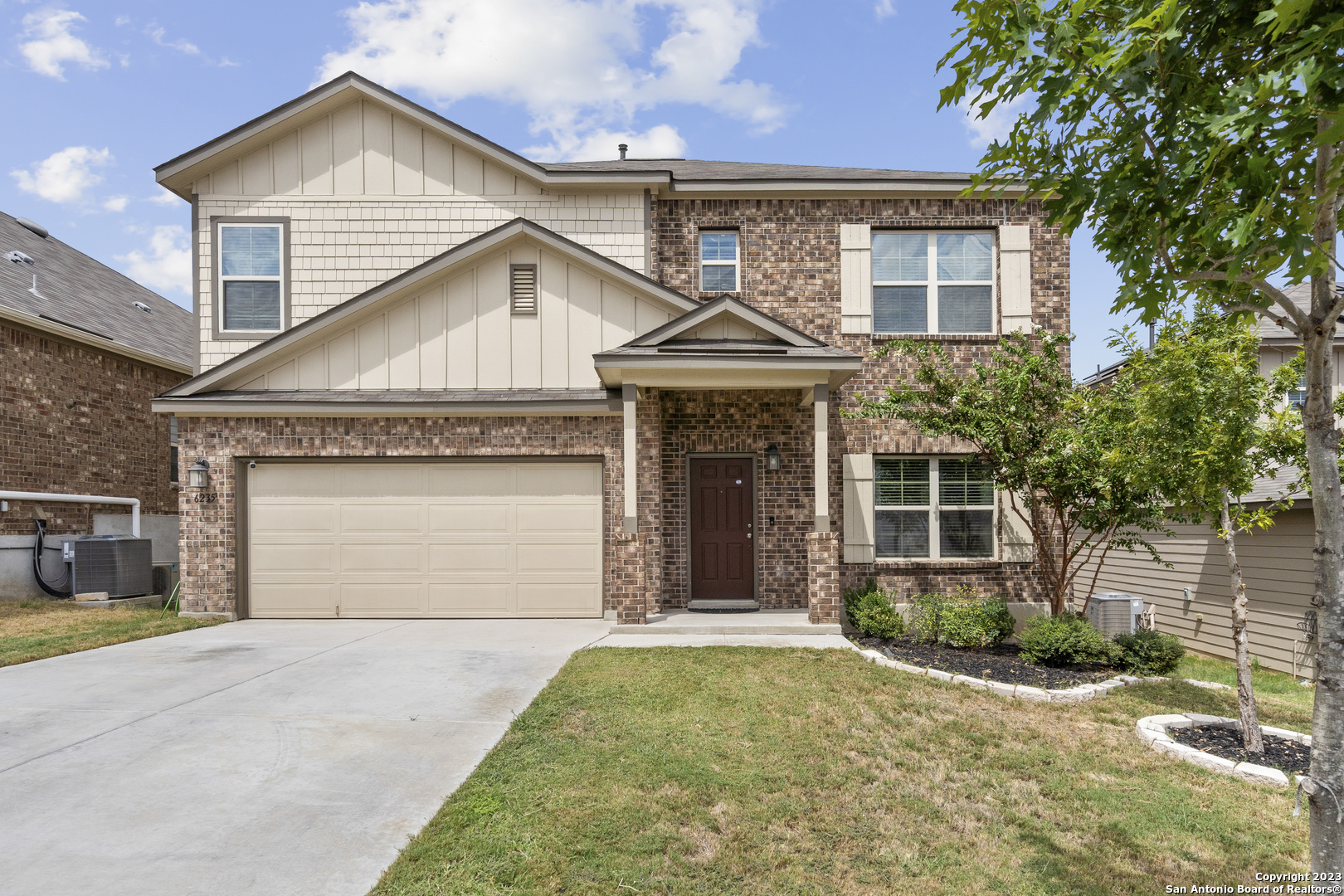 6235 Alta Puerta San Antonio, TX 78247 - Photo 1 of 33 a view of a white house with a yard and large tree