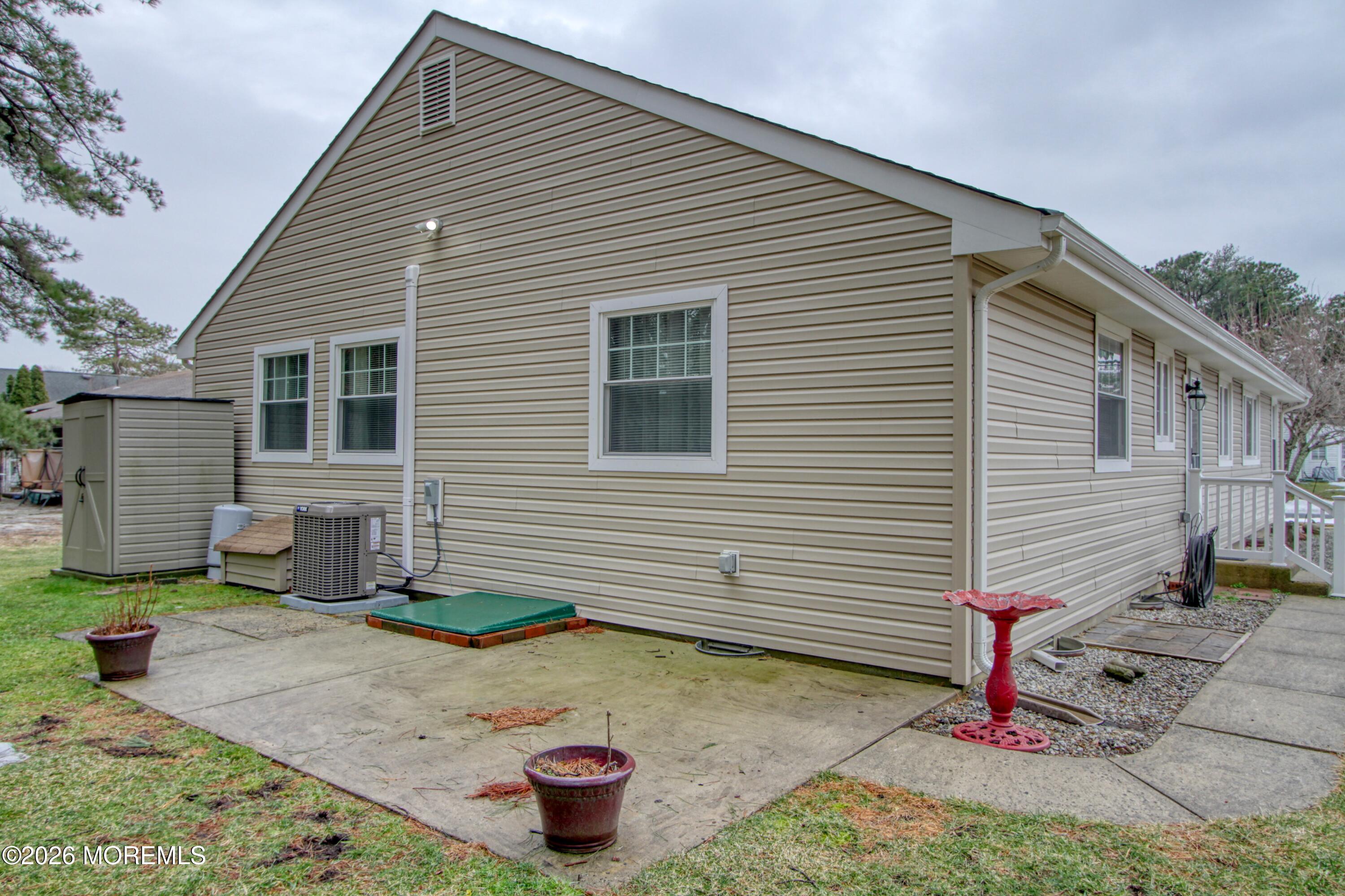111 Sunset Road, Unit 60 Whiting, NJ 08759 - Photo 12 of 23 a house view with a backyard and garden