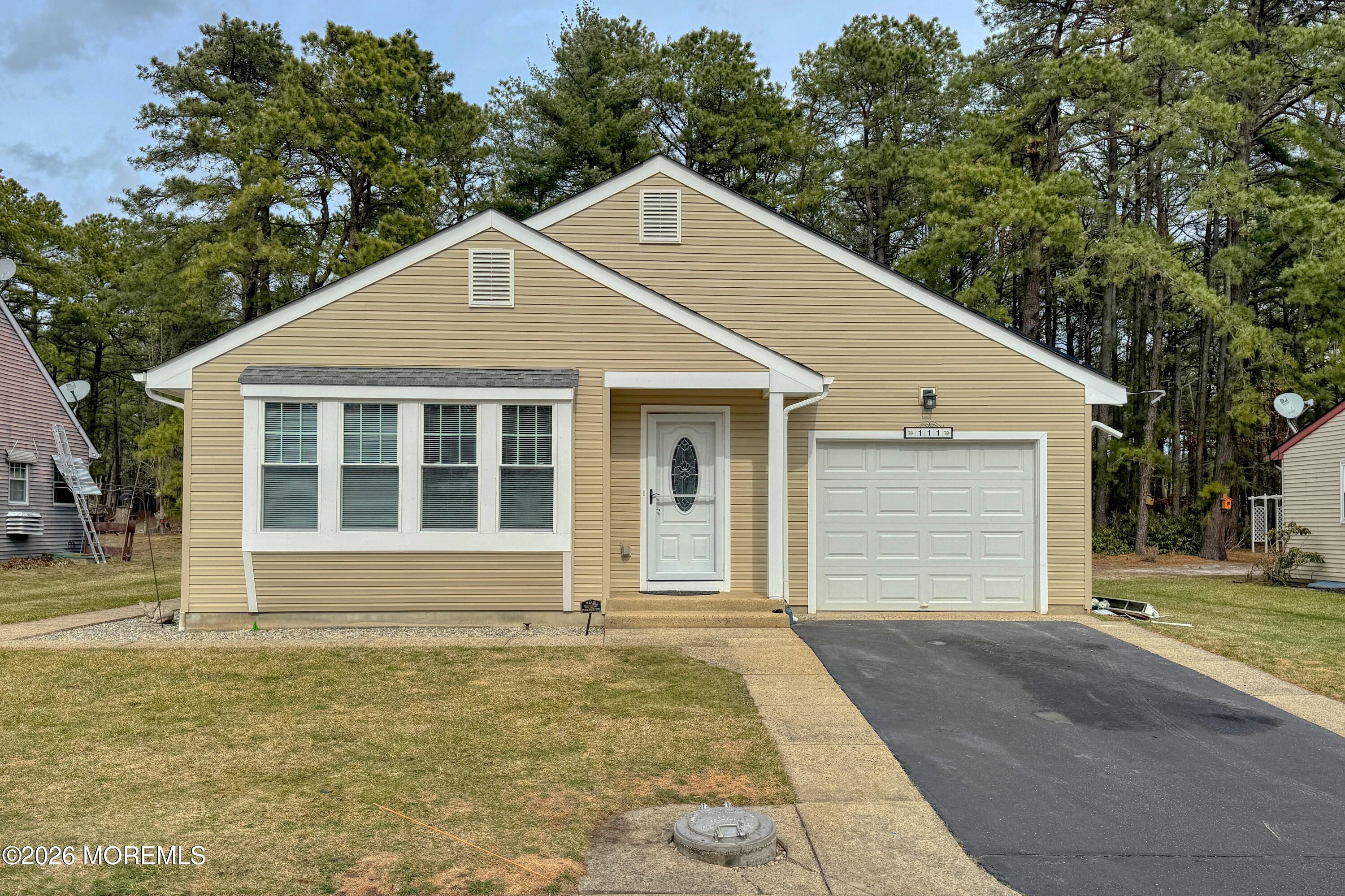 111 Sunset Road, Unit 60 Whiting, NJ 08759 - Photo 14 of 23 a front view of a house with a garden