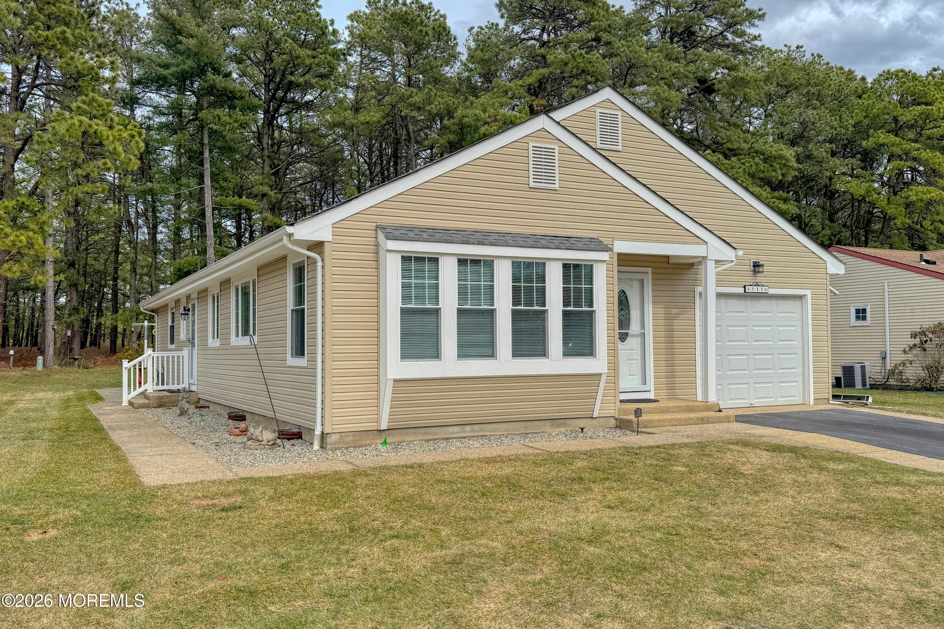 111 Sunset Road, Unit 60 Whiting, NJ 08759 - Photo 15 of 23 a house with trees in the background