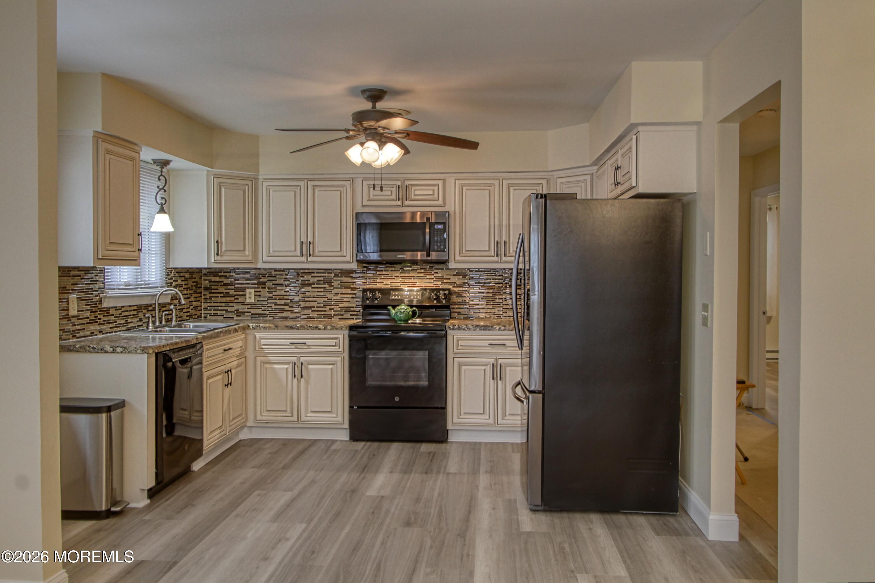 111 Sunset Road, Unit 60 Whiting, NJ 08759 - Photo 16 of 23 a kitchen with stainless steel appliances a refrigerator sink and microwave