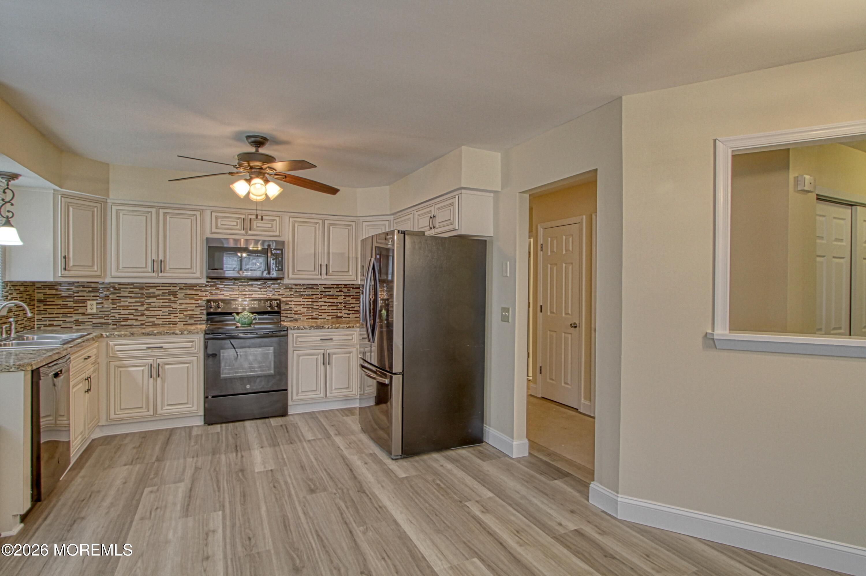 111 Sunset Road, Unit 60 Whiting, NJ 08759 - Photo 17 of 23 a kitchen with stainless steel appliances granite countertop a refrigerator and a stove top oven