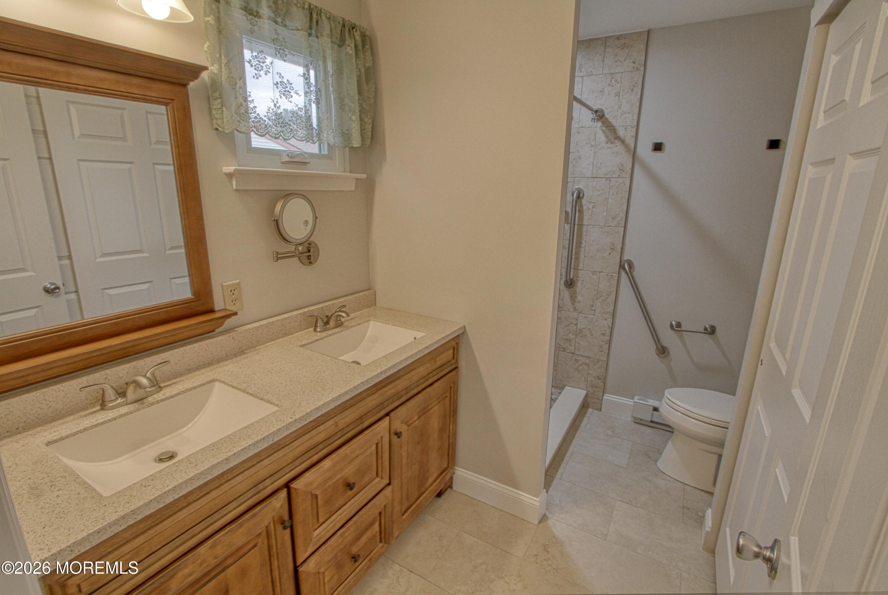 111 Sunset Road, Unit 60 Whiting, NJ 08759 - Photo 2 of 23 a bathroom with a sink a toilet and shower