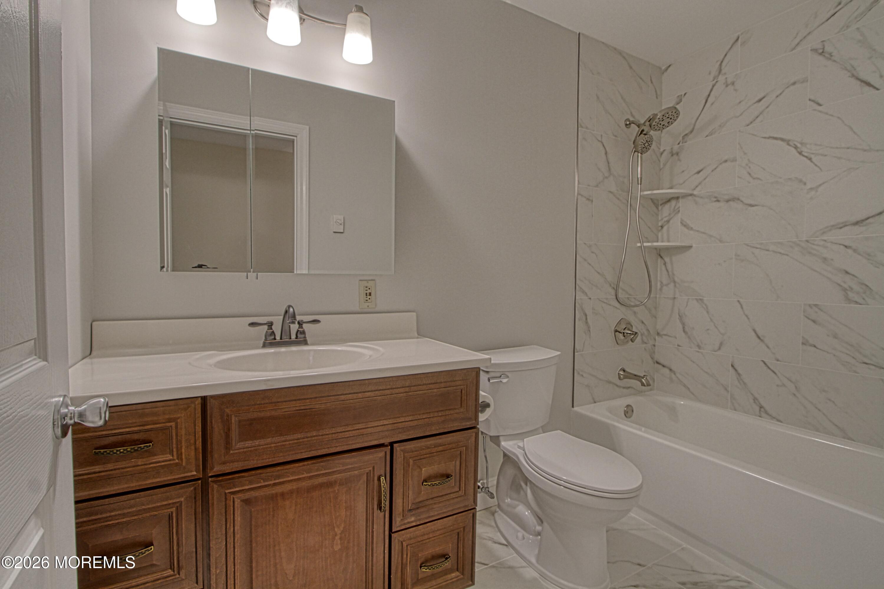 111 Sunset Road, Unit 60 Whiting, NJ 08759 - Photo 4 of 23 a bathroom with a granite countertop sink toilet and shower