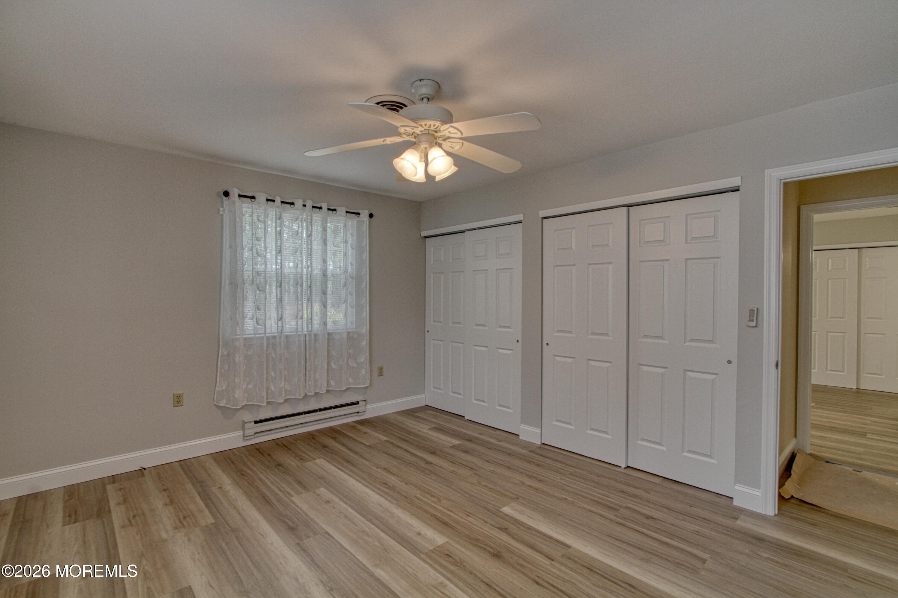 111 Sunset Road, Unit 60 Whiting, NJ 08759 - Photo 5 of 23 a view of empty room with wooden floor and fan