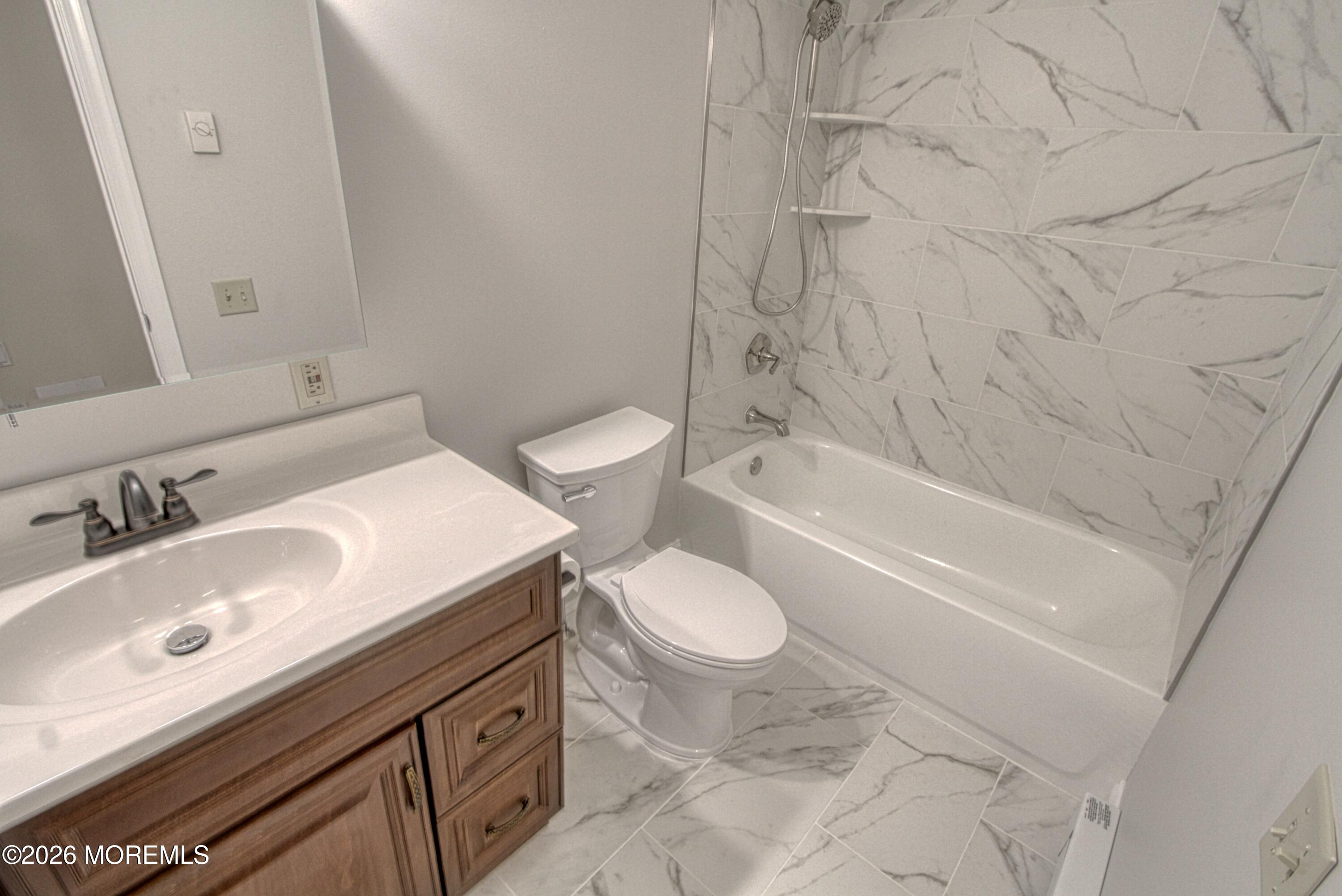 111 Sunset Road, Unit 60 Whiting, NJ 08759 - Photo 6 of 23 a bathroom with a sink toilet vanity and bathtub