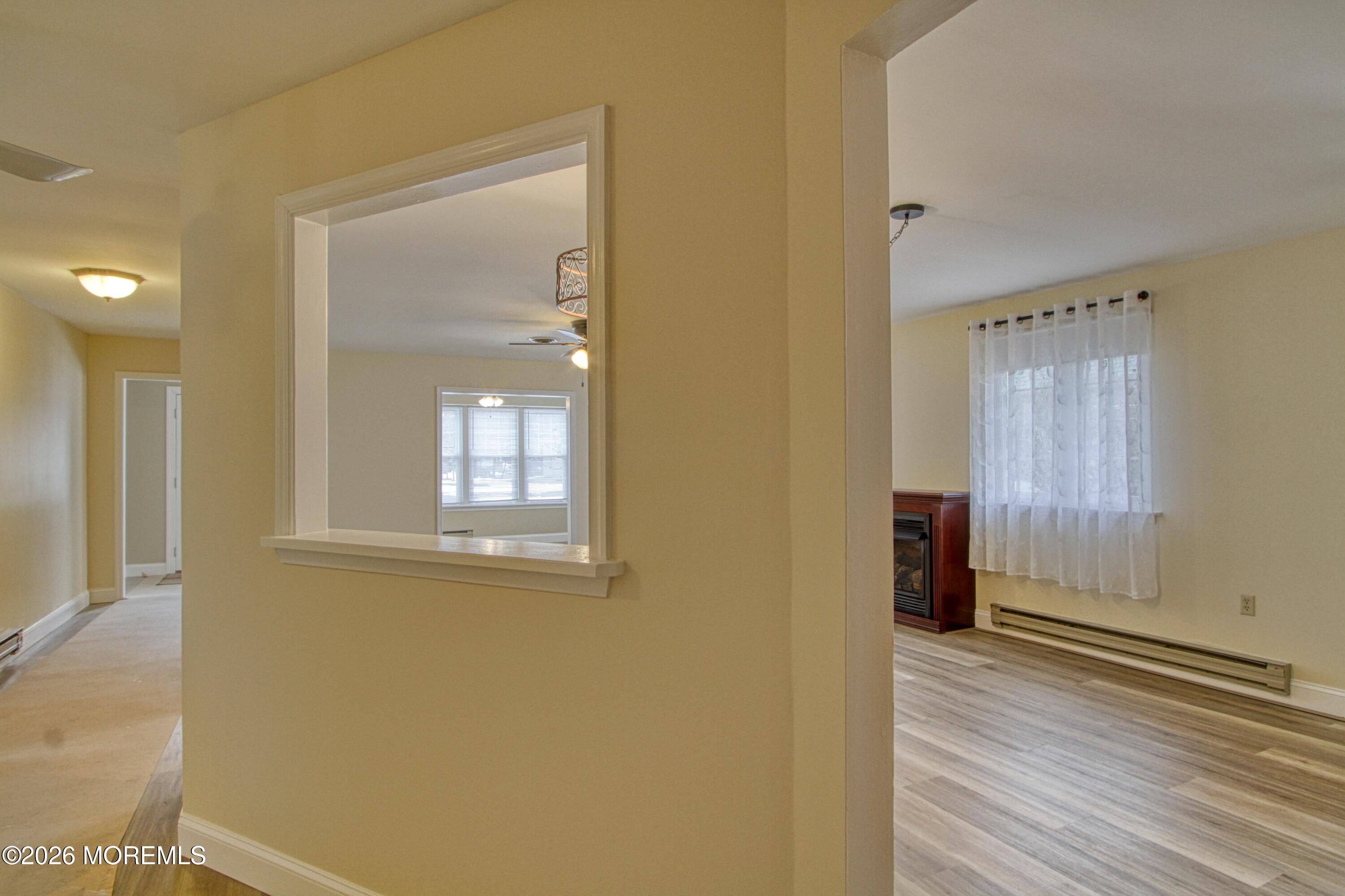111 Sunset Road, Unit 60 Whiting, NJ 08759 - Photo 7 of 23 a view of an empty room with wooden floor and a window