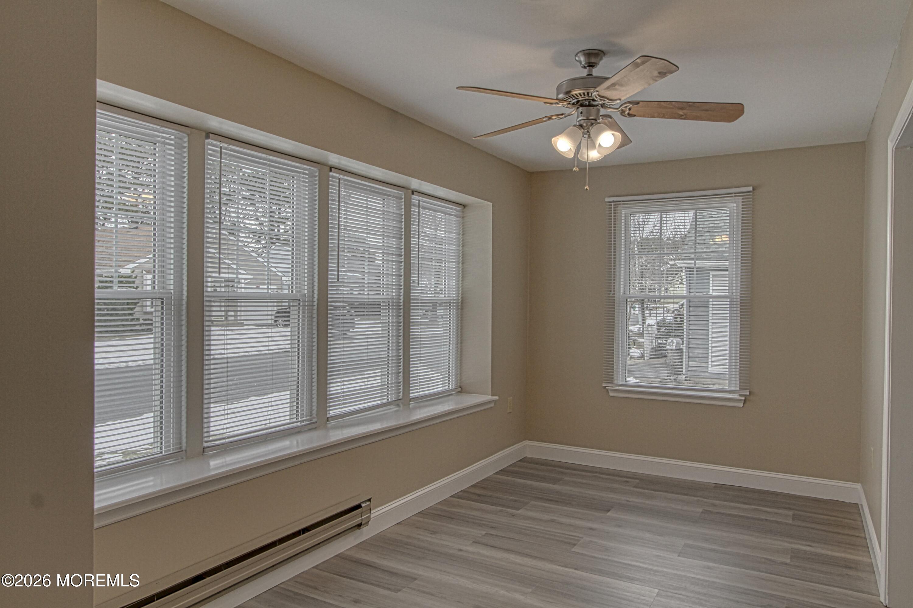 111 Sunset Road, Unit 60 Whiting, NJ 08759 - Photo 8 of 23 a view of an empty room with a window and wooden floor