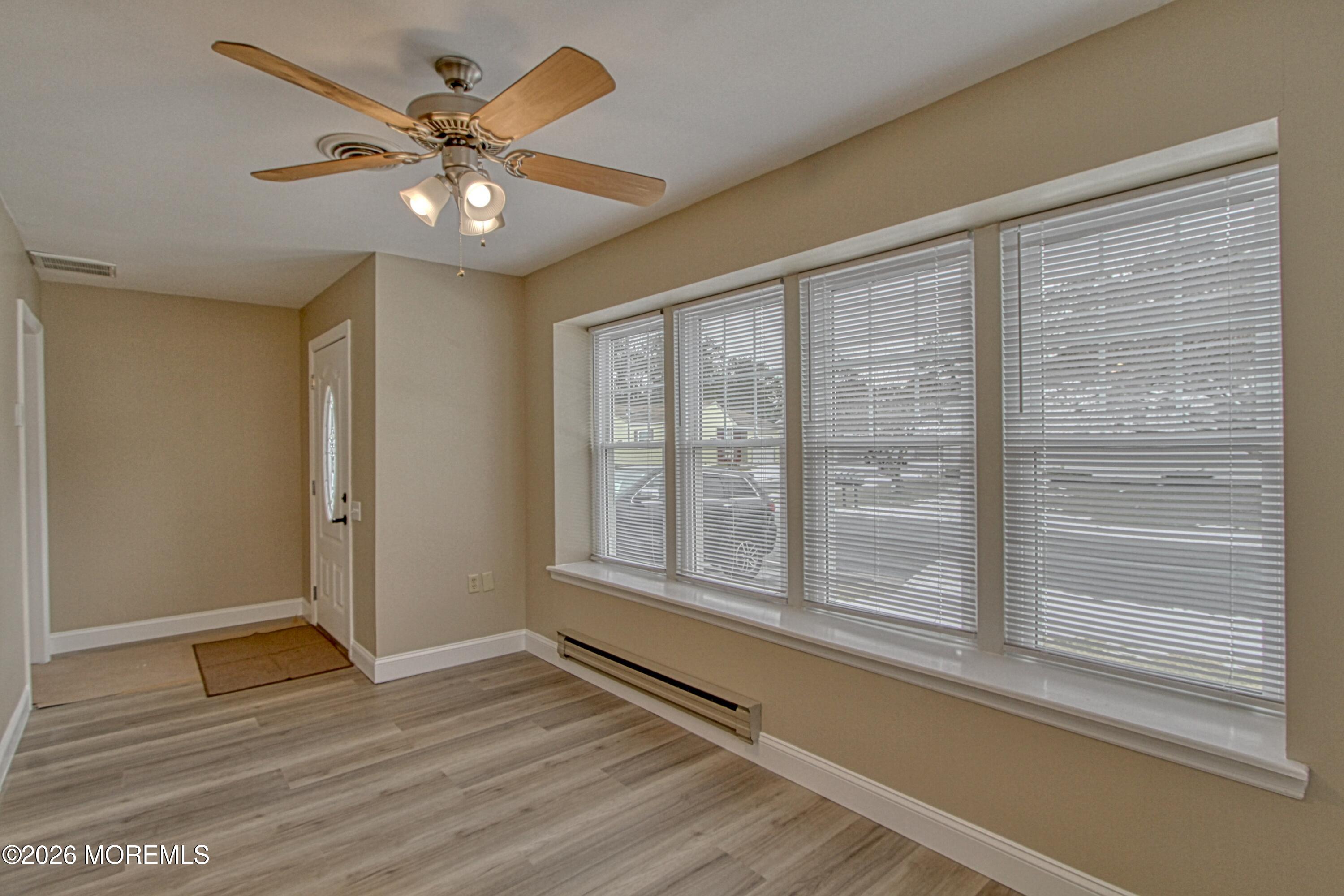 111 Sunset Road, Unit 60 Whiting, NJ 08759 - Photo 9 of 23 a view of an empty room with a window and wooden floor