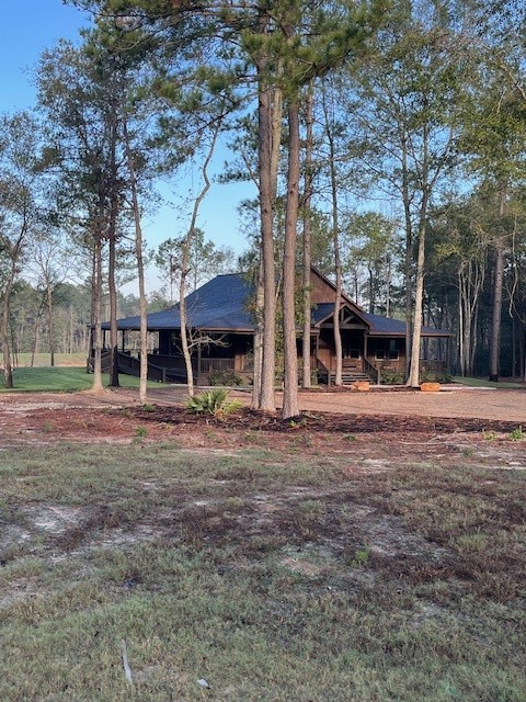 157 Rustic Ranch Drive New Waverly, TX 77358 - Photo 4 of 15 a view of a house with a yard