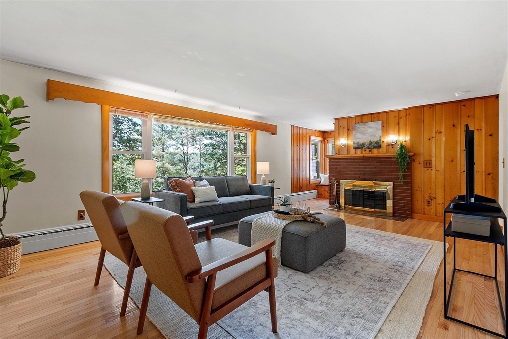 35 Philip Road Athol, MA 01331 - Photo 5 of 37 a living room with furniture a fireplace and a floor to ceiling window
