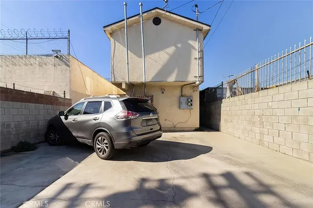 a front view of a house with parking area