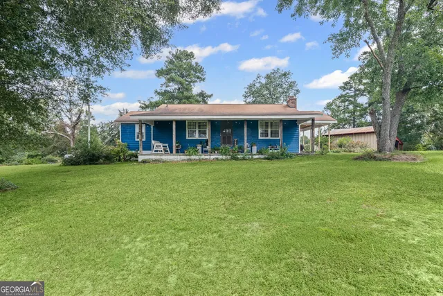 a front view of house with yard and outdoor seating