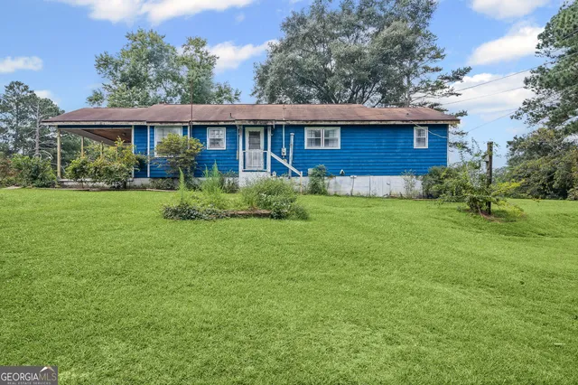 a backyard of a house with yard and trampoline