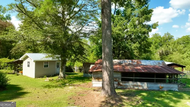 a view of yard with swimming pool and green space