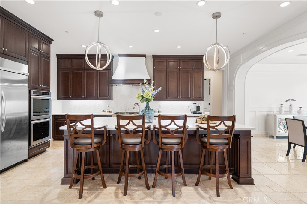 878 North Landa Way Brea, CA 92821 - Photo 12 of 52 a kitchen with stainless steel appliances kitchen island a table and chairs in it