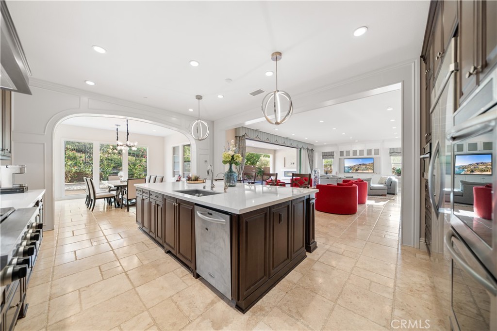 878 North Landa Way Brea, CA 92821 - Photo 14 of 52 a large kitchen with stainless steel appliances granite countertop a lot of cabinets and wooden floor