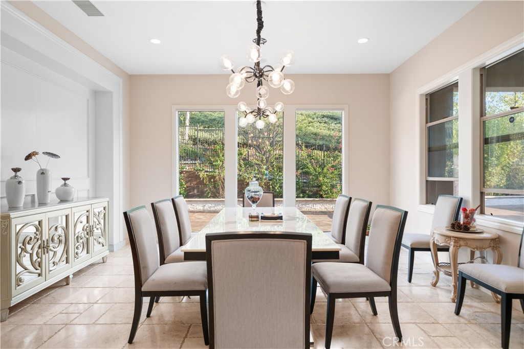 878 North Landa Way Brea, CA 92821 - Photo 15 of 52 a dining room with furniture a chandelier and wooden floor