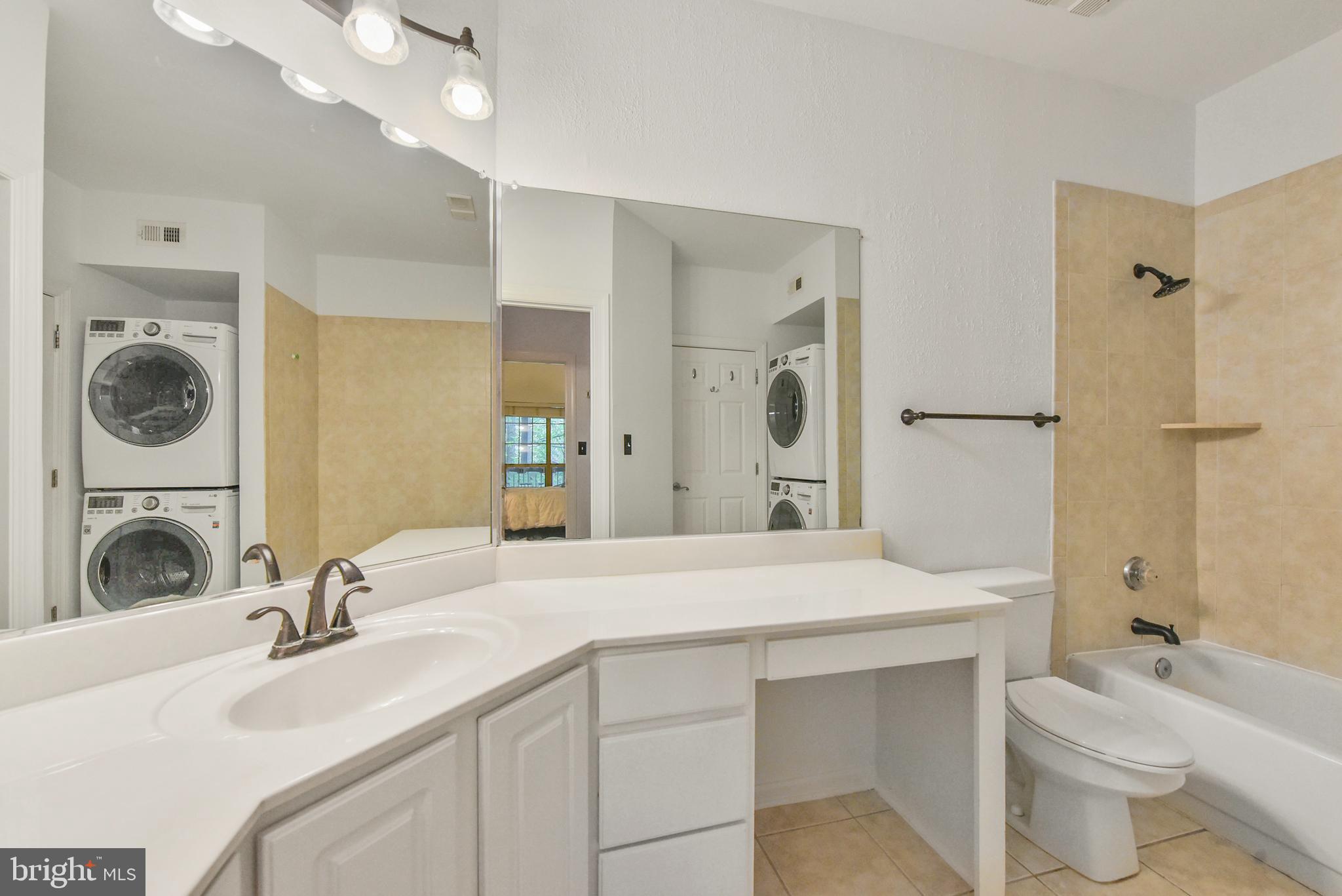 3909 Penderview Drive, Unit 1923 Fairfax, VA 22033 - Photo 15 of 19 a bathroom with a sink double vanity and a mirror
