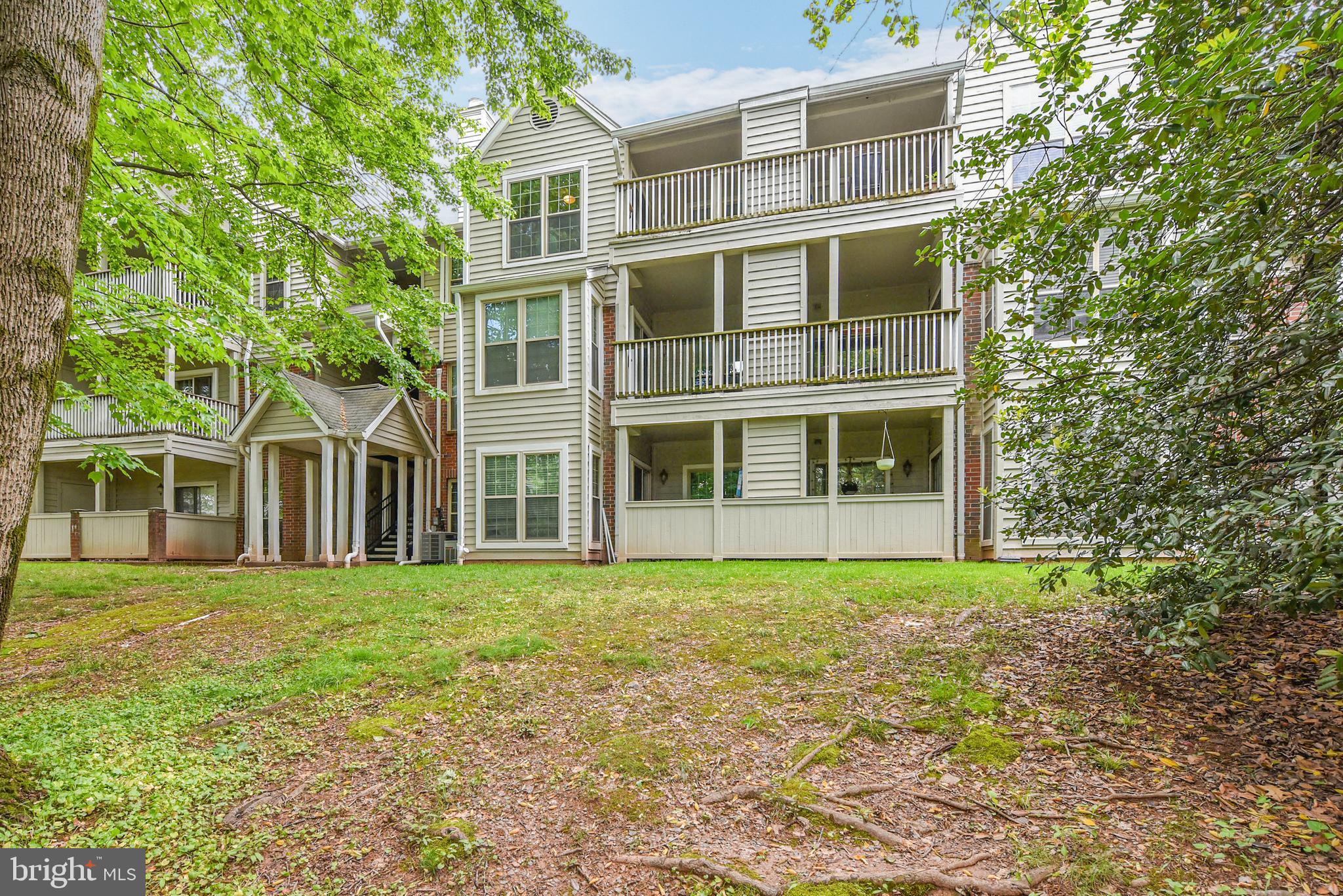 3909 Penderview Drive, Unit 1923 Fairfax, VA 22033 - Photo 19 of 19 a big room with large windows and a yard