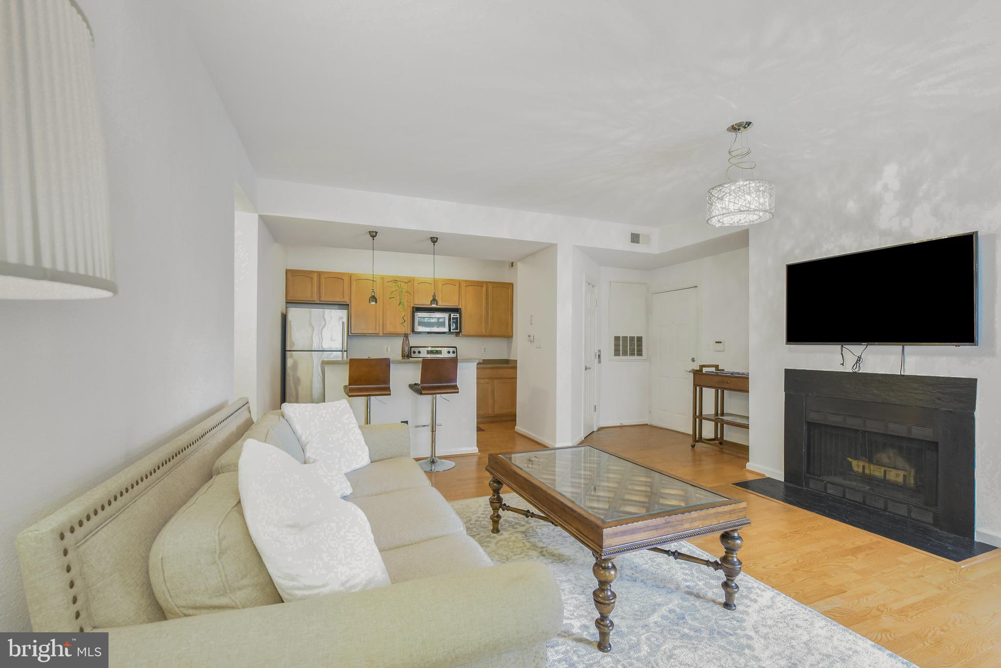 3909 Penderview Drive, Unit 1923 Fairfax, VA 22033 - Photo 3 of 19 a living room with furniture and a flat screen tv