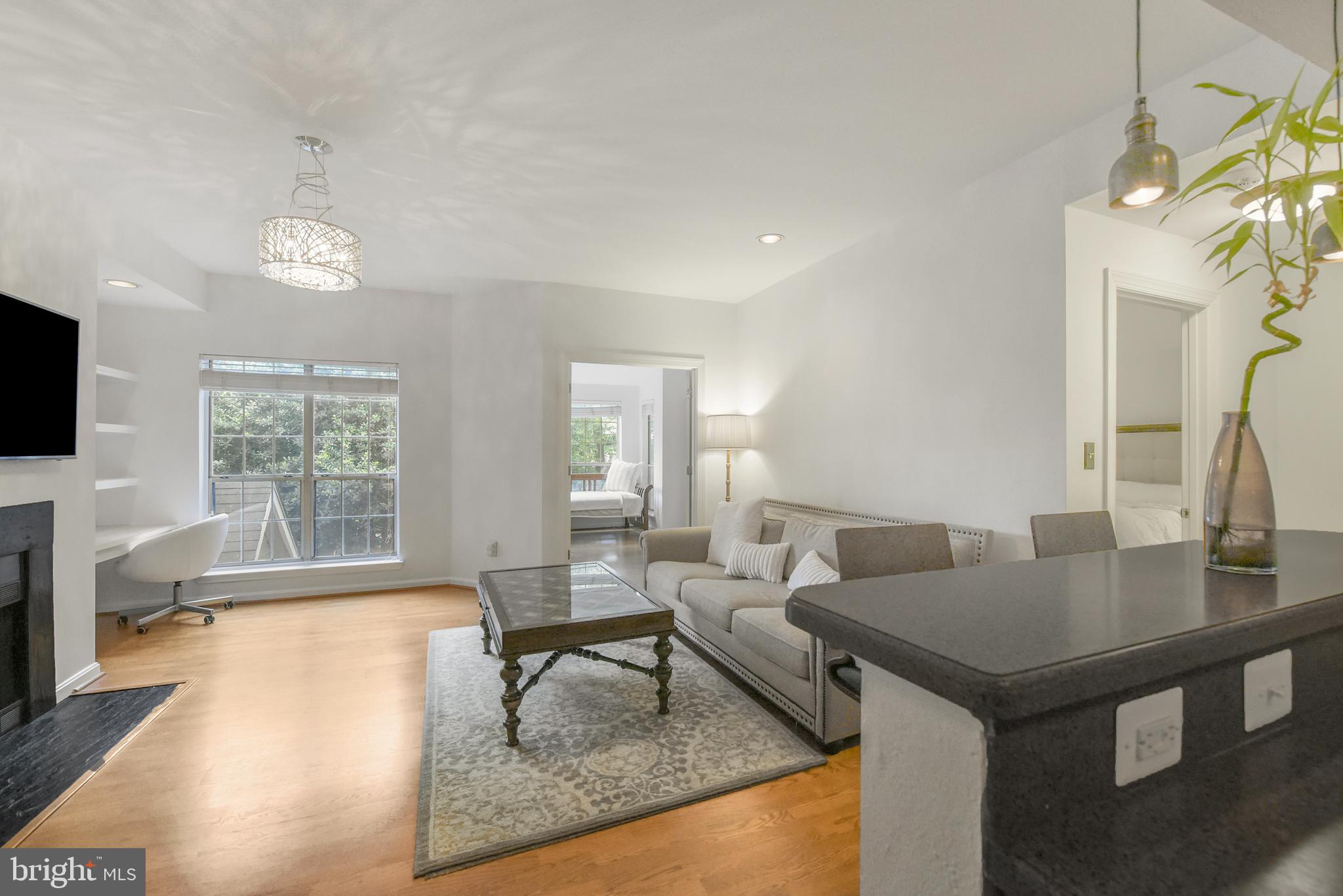 3909 Penderview Drive, Unit 1923 Fairfax, VA 22033 - Photo 6 of 19 a living room with furniture and a flat screen tv
