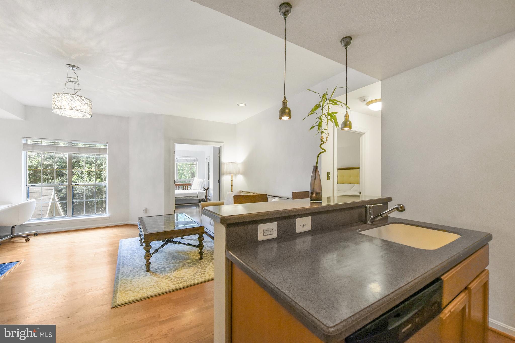 3909 Penderview Drive, Unit 1923 Fairfax, VA 22033 - Photo 7 of 19 a view of a center island table and chairs in it