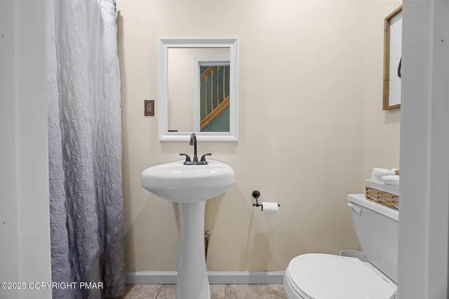 a bathroom with a sink toilet and mirror