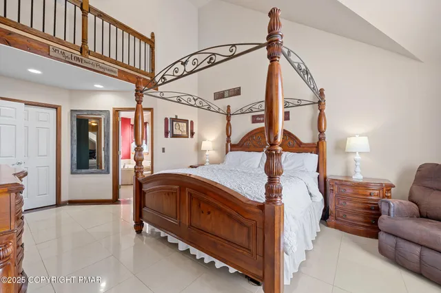 a bedroom with a large bed and a chandelier