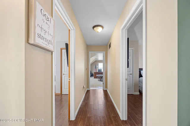 a view of a hallway with wooden floor