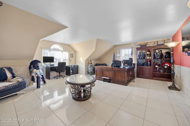 a living room with lots of furniture and gym equipment