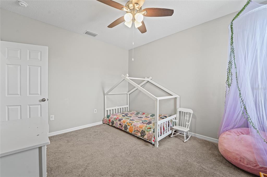 8903 Arabella Lane Seminole, FL 33777 - Photo 34 of 47 a bedroom with a bed and a chandelier