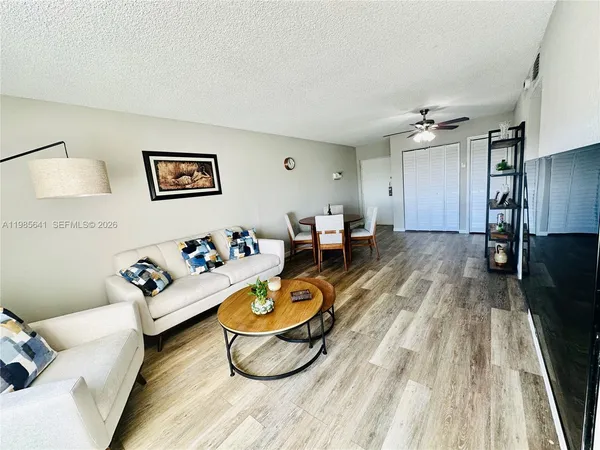 a living room with furniture and wooden floor