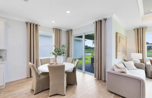 a large kitchen with kitchen island a large counter top space a sink stainless steel appliances and windows